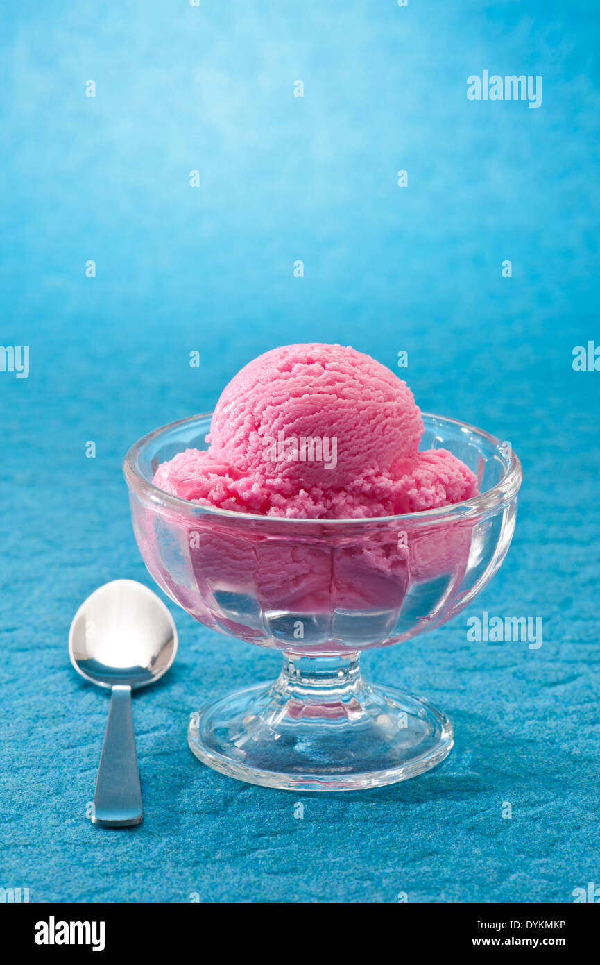 raspberry ice cream over a blue background Stock Photo - Alamy