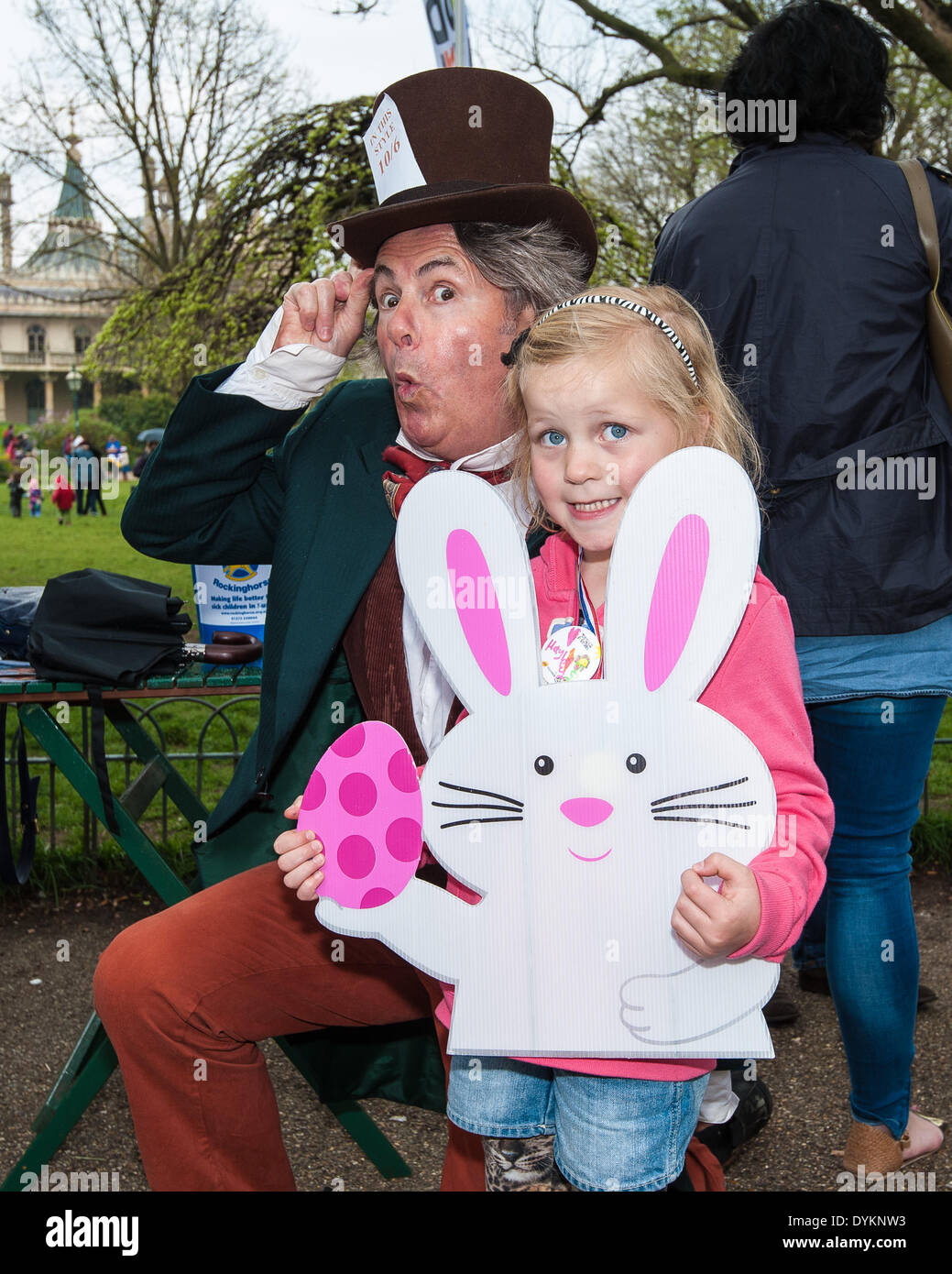 Brighton, UK. 21st Apr, 2014. The Mad Hatter [Rob Marks] with Hayley Lewis at the Easter egg games as Brighton & Hove Food and Drink Festival hold an Easter Egg hunt in aid of the children's charity Rockinghorse in Pavilion Gardens, Brighton. Children complete games to find Easter eggs around the Brighton Pavilion gardens: egg and spoon race, skipping, quoits and card games before making a badge and receiving a medal for their efforts. The event is sponsored by PHS Group PLC and raises over £400 for the Rockinghorse charity.  Credit:  Julia Claxton/Alamy Live News Stock Photo