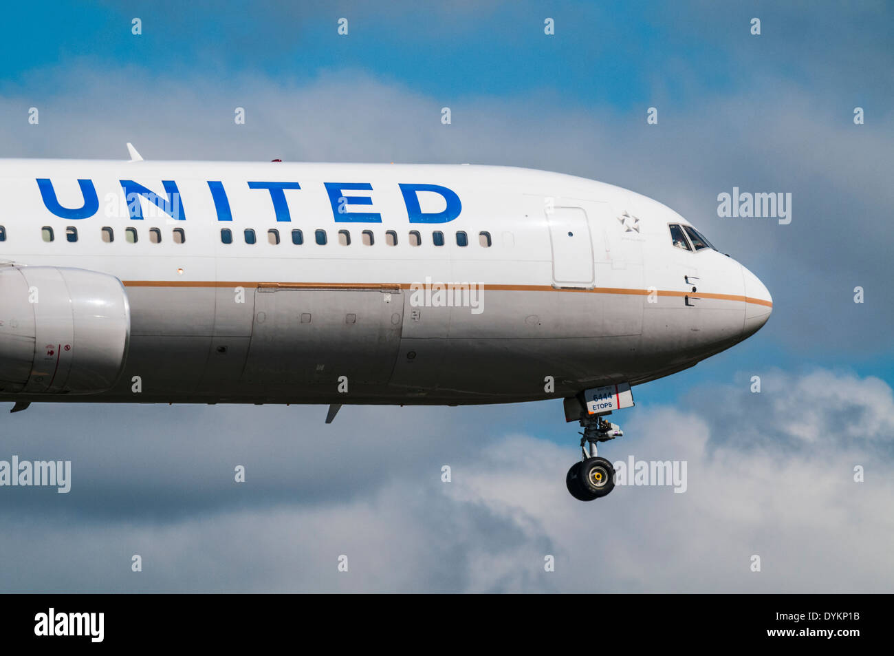 Front of a United Airlines Boeing 777 plane on approach to land with its landing gear down Stock Photo