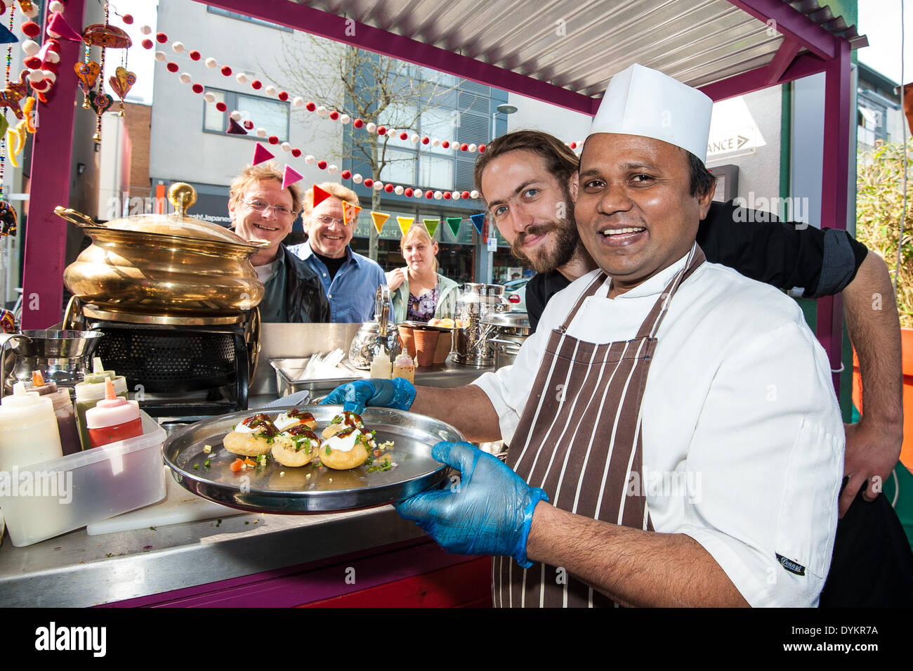 Brighton, UK. 21st April, 2014. At the Chilli Pickle in Jubilee Square Kumar serves up pani puri to visitors on the Brighton & Hove Food and Drink Festival Food Trail in Brighton who sample the delights of 10 local restaurants and bars whilst following the trail around The Lanes and North Laine of Brighton. Taking part were Aguadulce, Be At One, Boho Gelato, La Cave a Fromage, The Chilli Pickle, La Choza, Moshimo, Julien Plumart, The Manor, Yum Yum Ninja. photo Credit: Julia Claxton/Alamy Live News Stock Photo