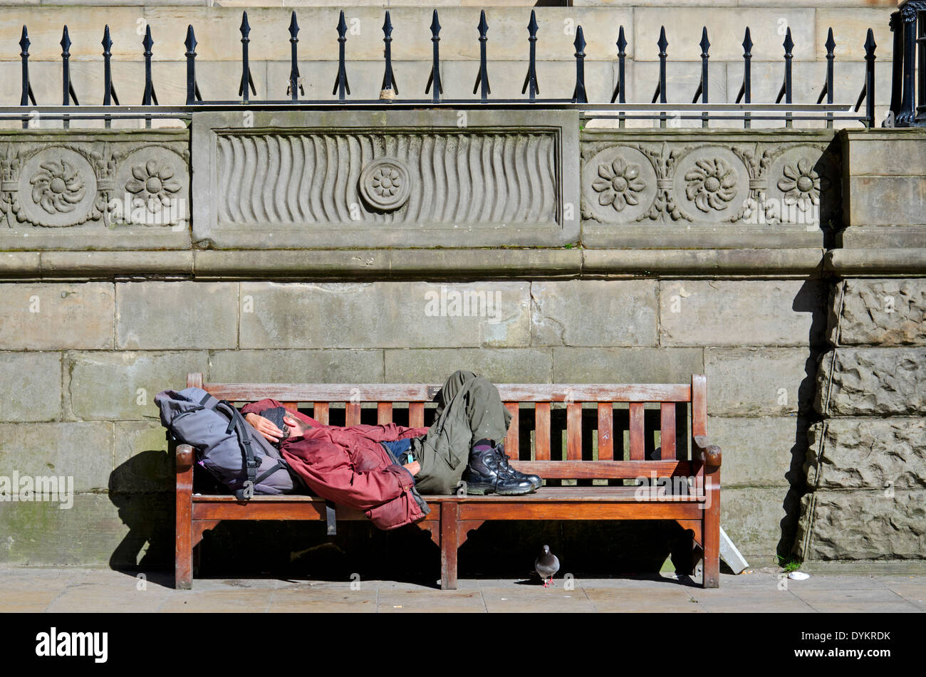 A  vagrant asleep on a bench in the centre of Edinburgh. Stock Photo