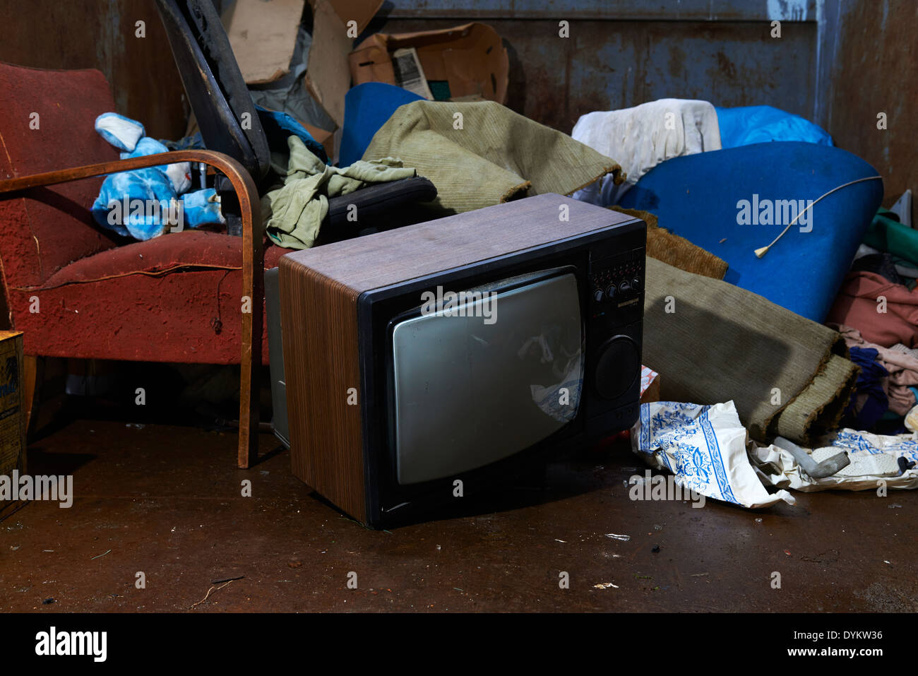 Retro old vintage tv television with pile of rubbish in garbage container Stock Photo