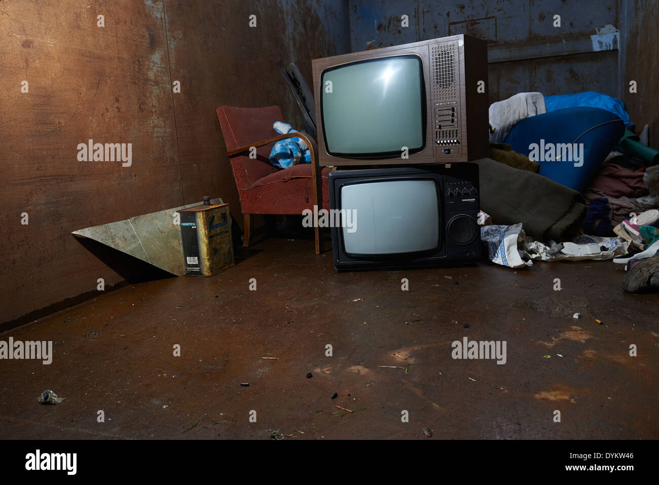Retro old vintage tv television with pile of rubbish in garbage container Stock Photo