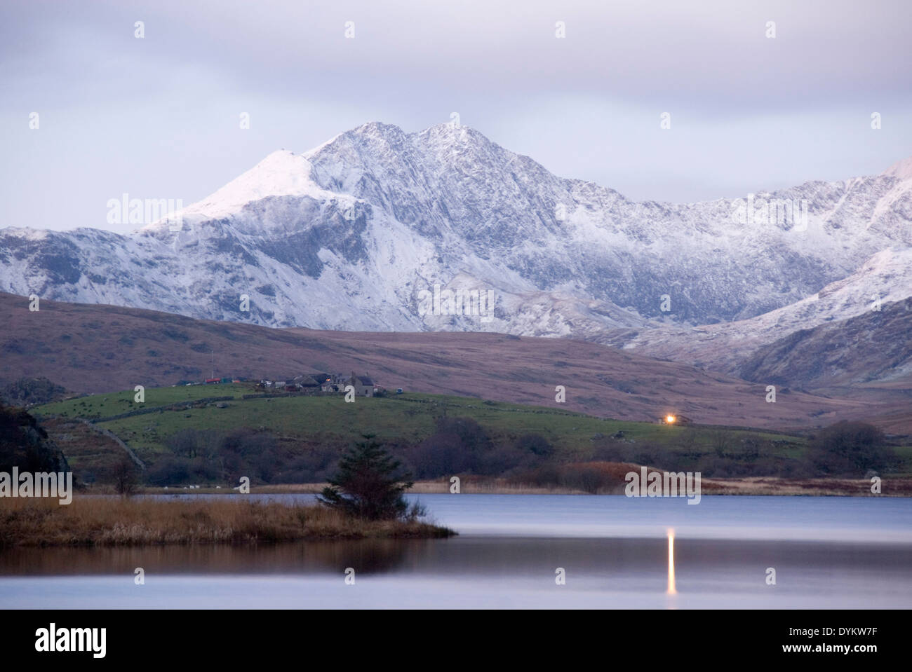Snow covered mount Snowdon as clouds lift on a winter morning, Snowdonia Circle, Llynnau Mymbyr lakes, Capel Curig, Wales, UK Stock Photo