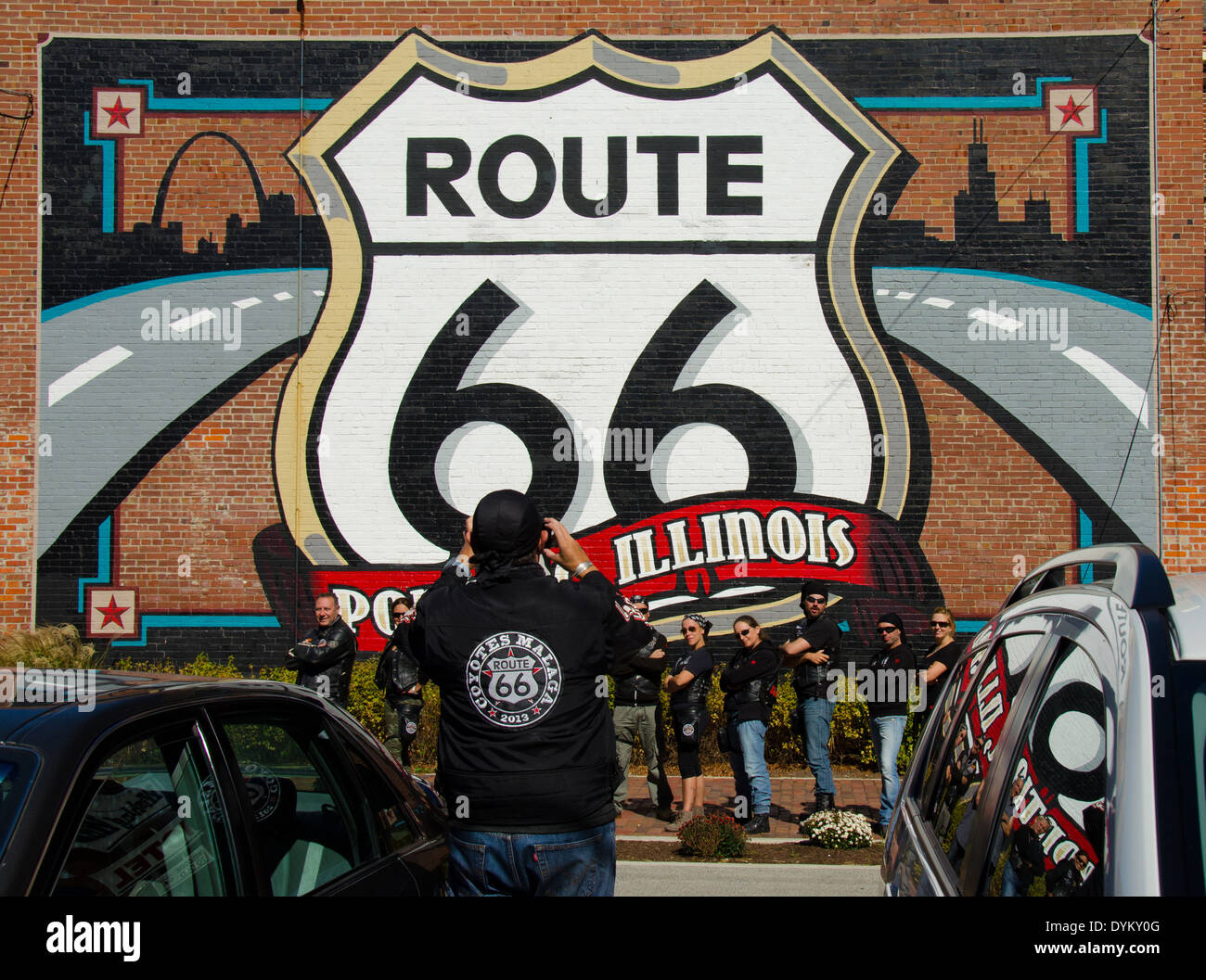 Photographer taking a photo of the Route 66 mural painted on the back of the Route 66 Hall of Fame and Museum in Pontiac, IL Stock Photo