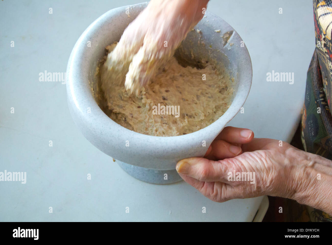 Whisking the bread roll dough by hand while baking, Finland, Europe