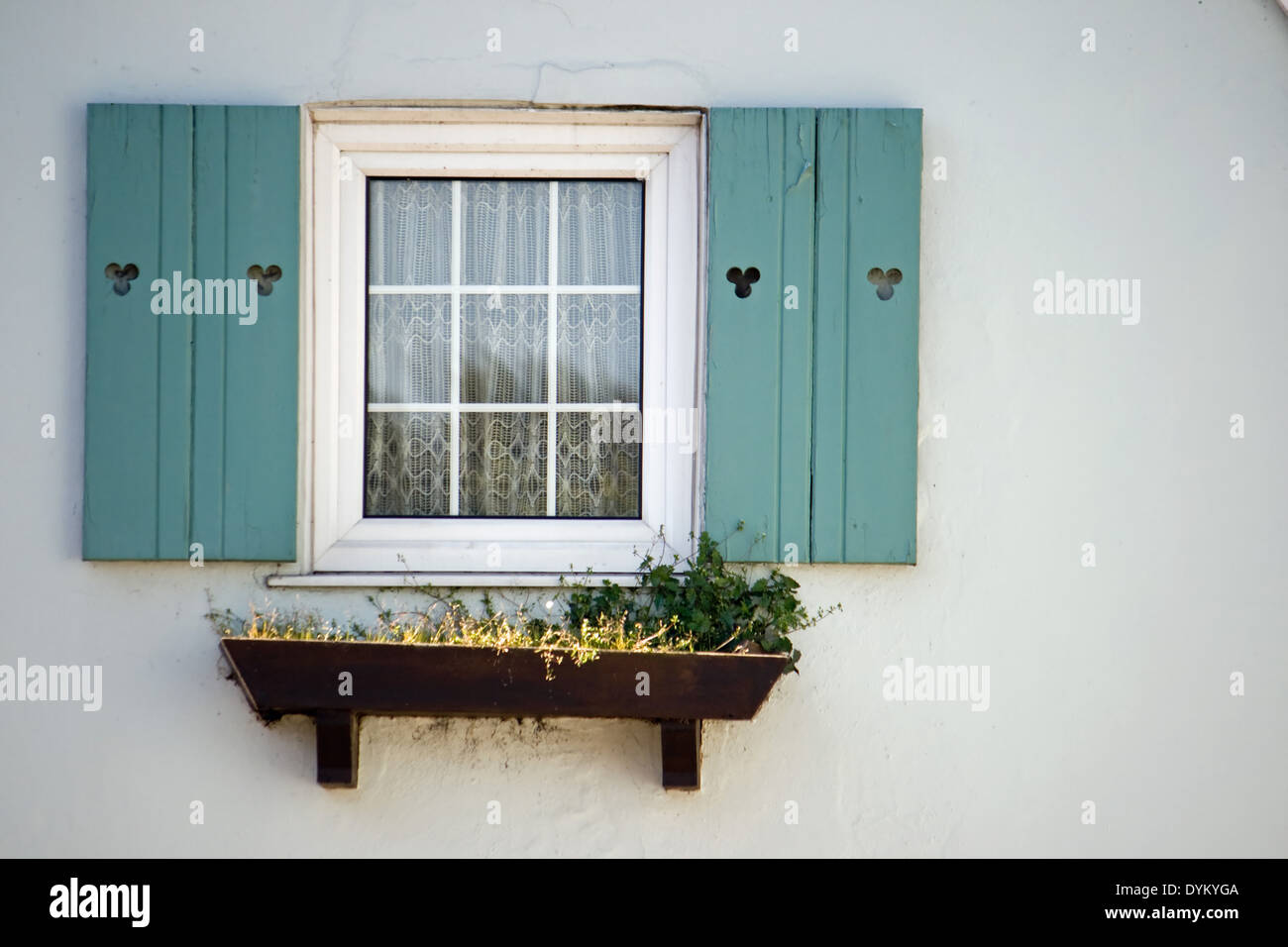 Window with shutters and a window box. Stock Photo