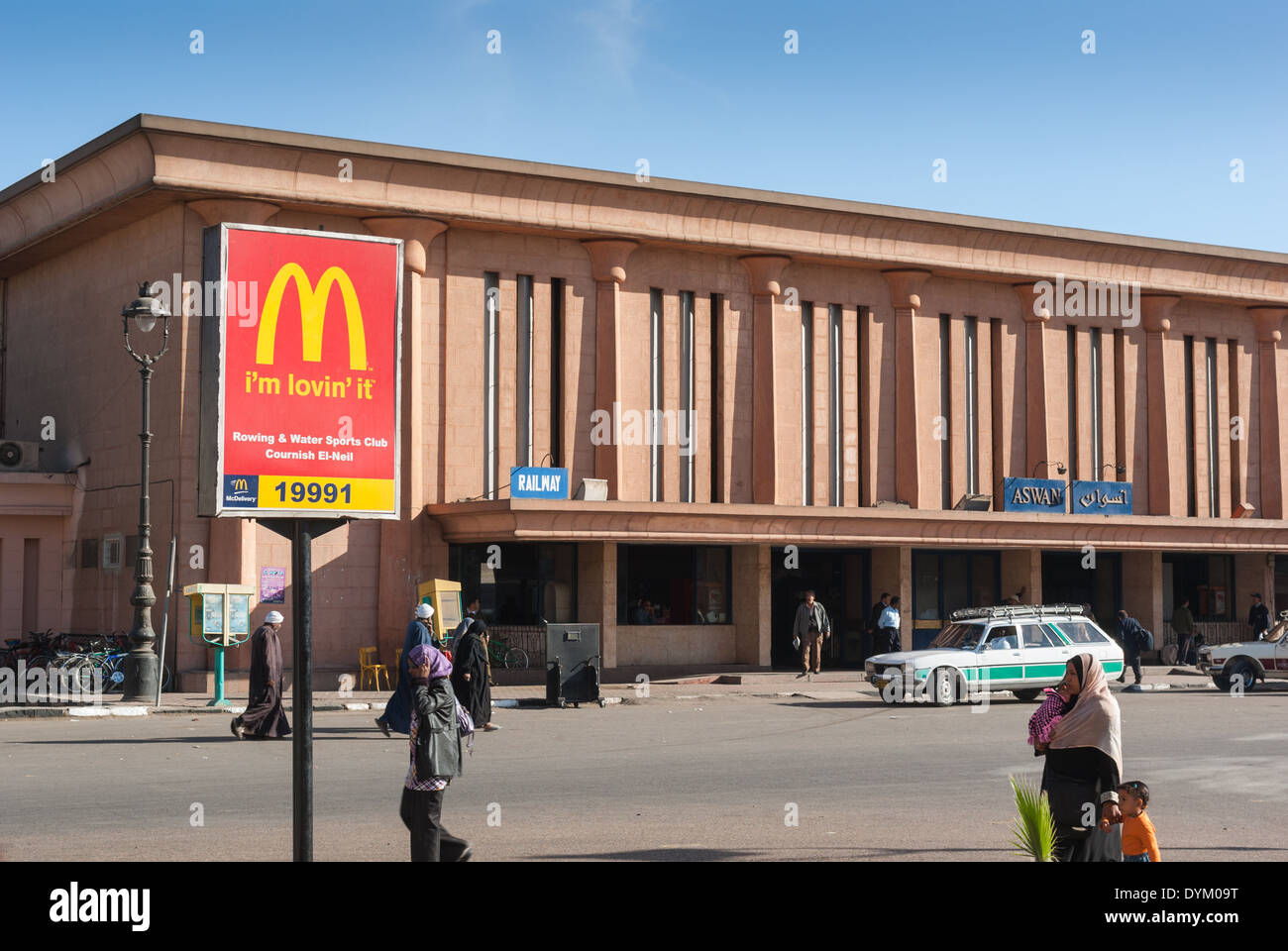 McDonalds Signpost and Aswan Railway Station, Aswan, Egypt Stock Photo