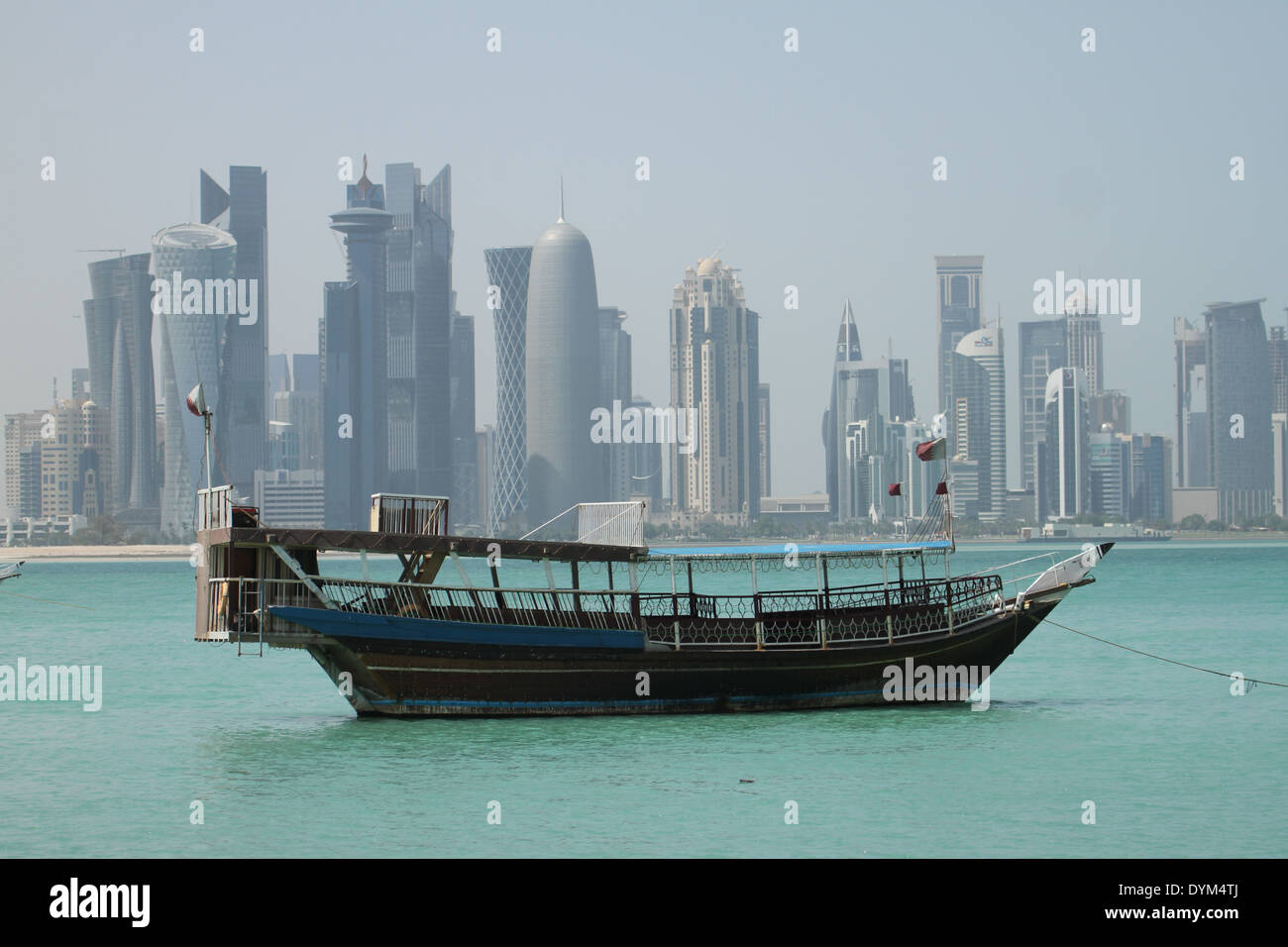 Doha, Qatar - 21 April 2014: A dhow seen with a backdrop of the Doha skyscrapers seen from the Corniche. Credit: David Mbiyu/Alamy Live News Stock Photo