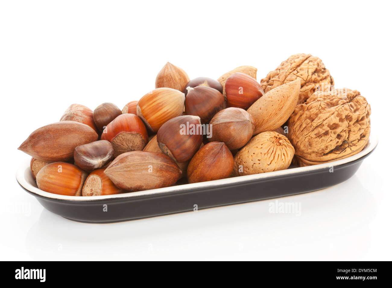 Nuts collection in black bowl isolated on white background. Healthy snack concept. Stock Photo