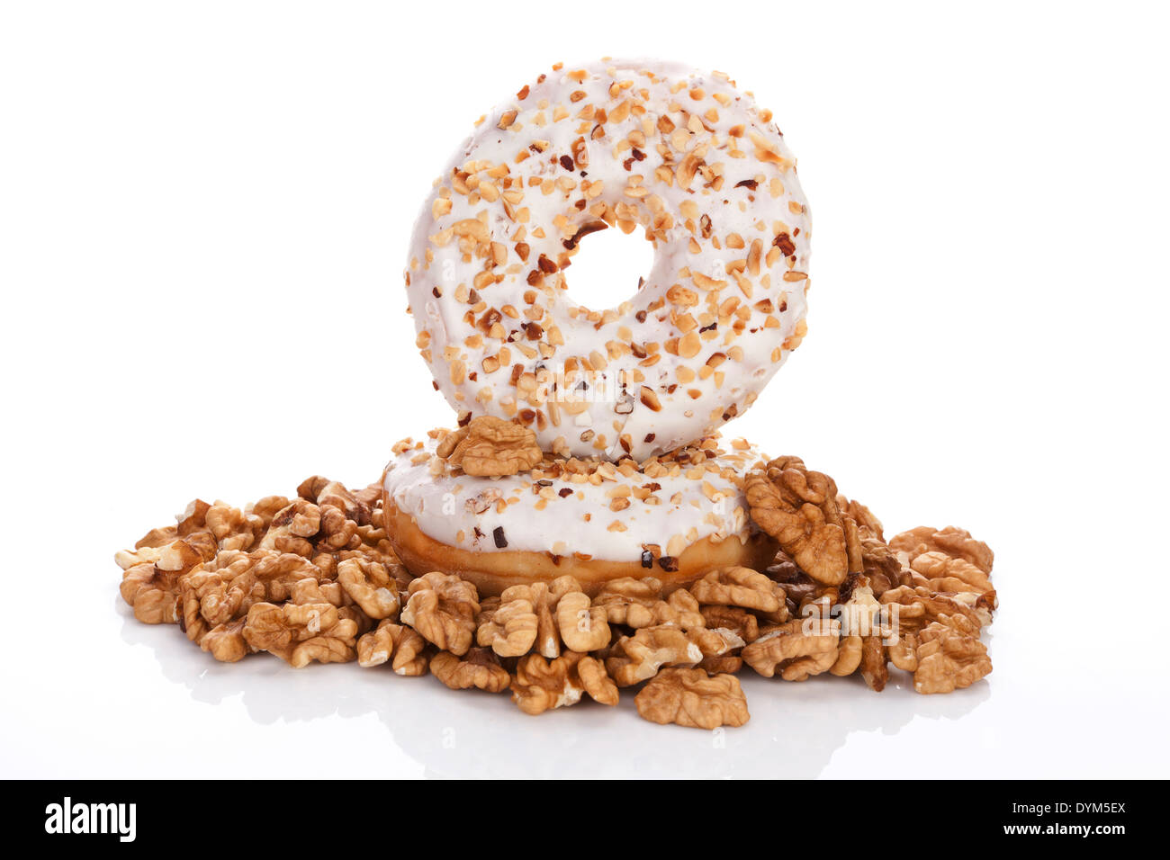 Delicious donuts with fresh walnuts isolated on white background