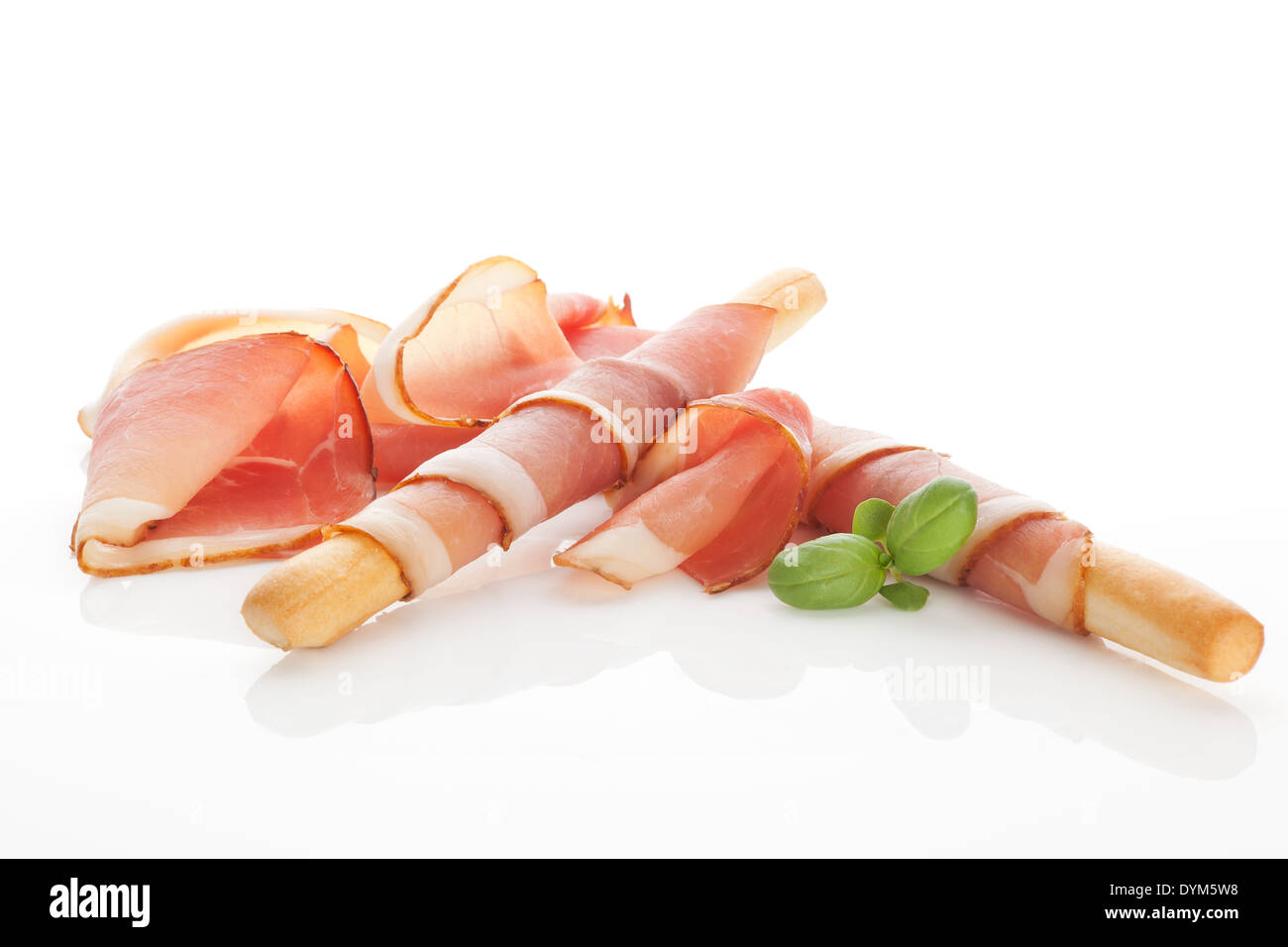 Culinary food. Parma ham prosciutto with grissini bread sticks isolated on white background