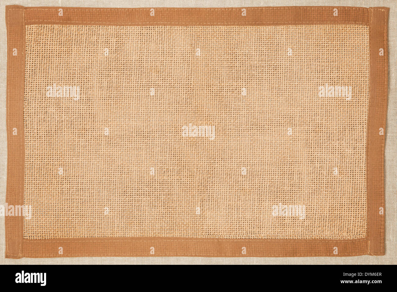 Brown natural textured fabric background with natural frame. Stock Photo
