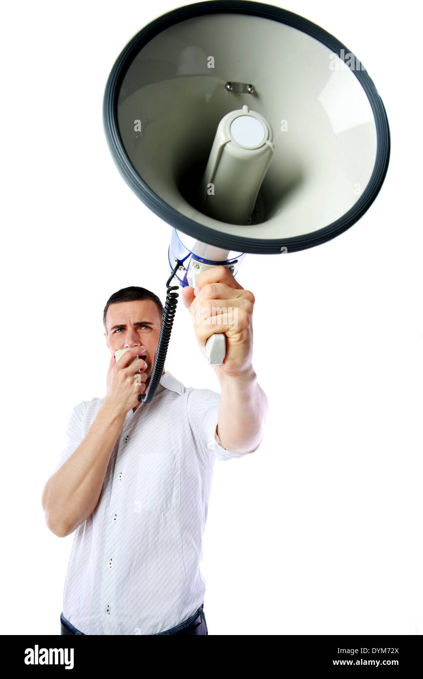 Portrait of a man roaring loudly into megaphone over white background Stock Photo
