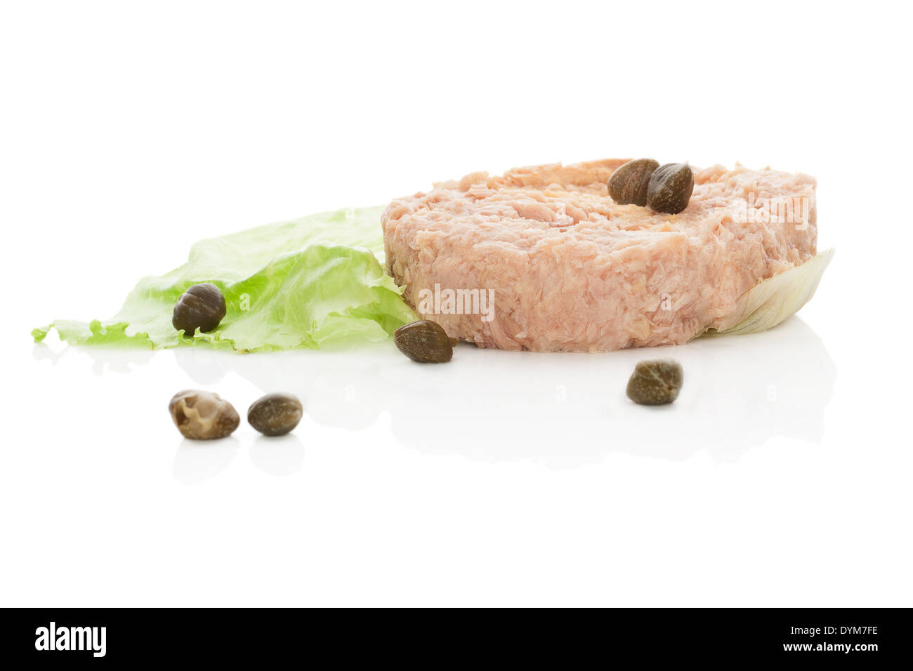 Delicious tuna steak with capers on lettuce salad leaf isolated on