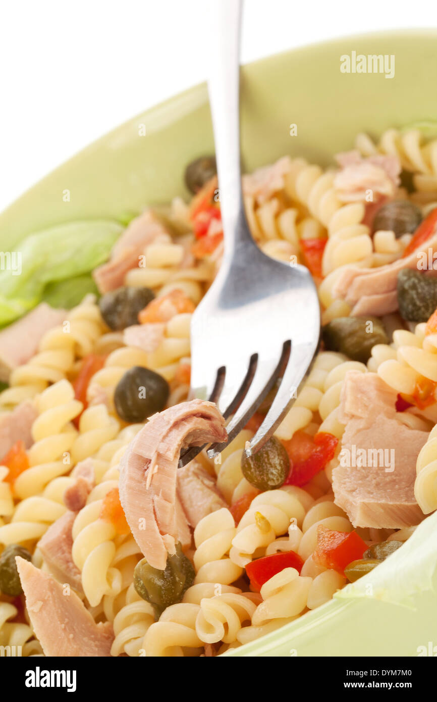 Delicious pasta with tuna, capers and vegetable in green bowl. Tuna
