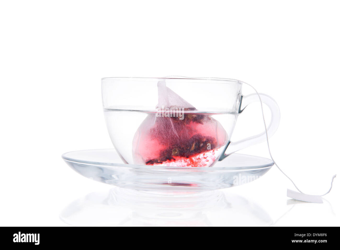 Tea Bag In Transparent Cup With Water Isolated On White Background. Red
