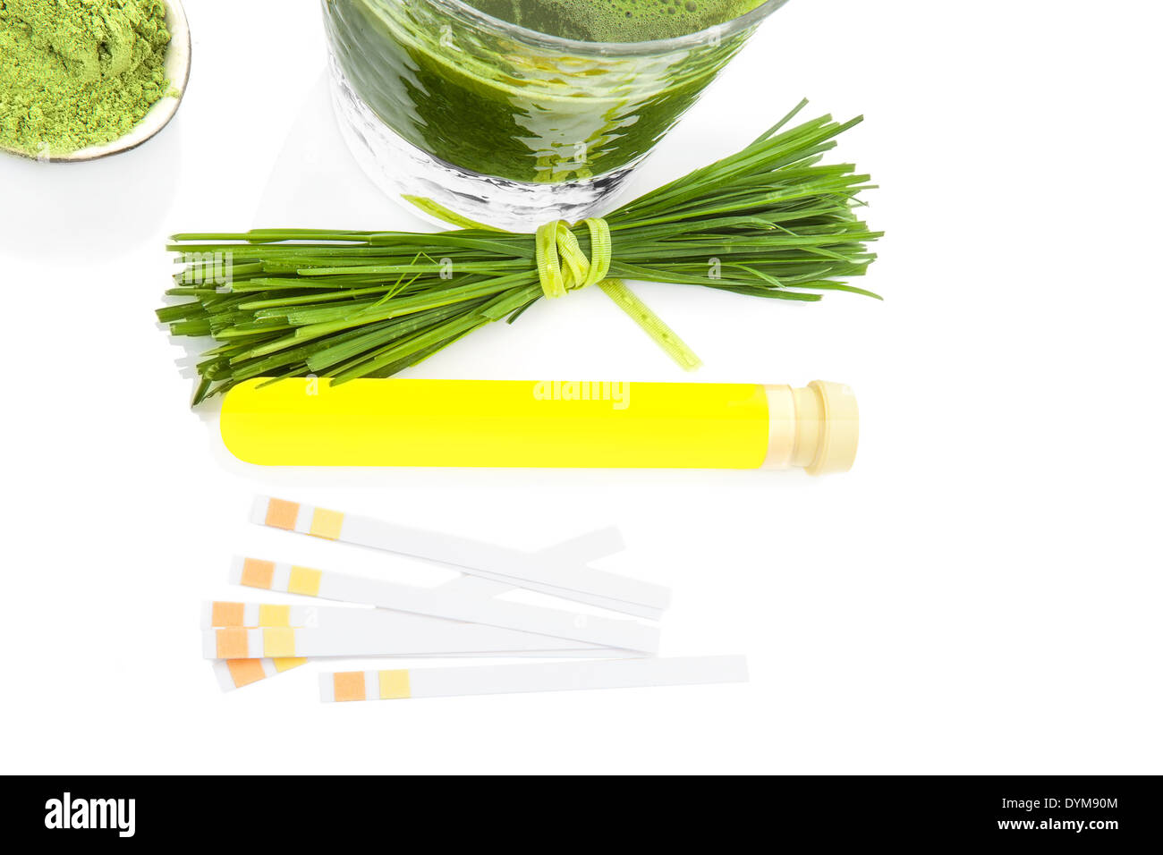 Urine sample in test tube, pH litmus paper test strip, ground