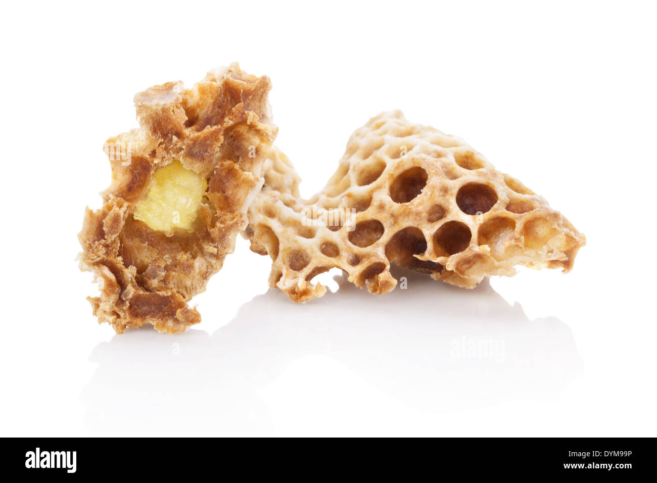Royal jelly in honeycomb isolated on white background. Beauty and antiaging concept. Organic and natural cosmetics. Stock Photo