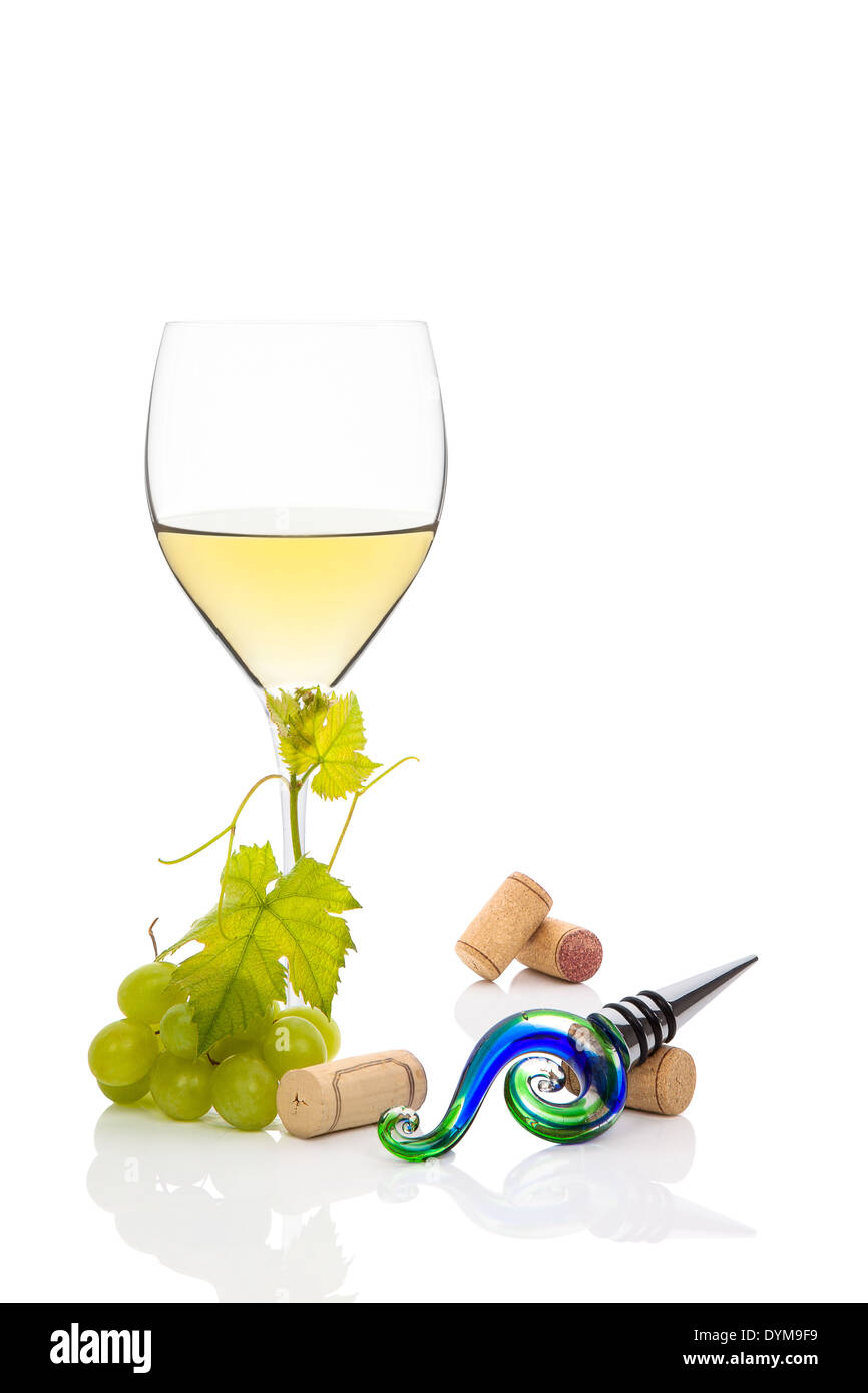 White wine with green grapes, wine corks and vine leaves isolated on