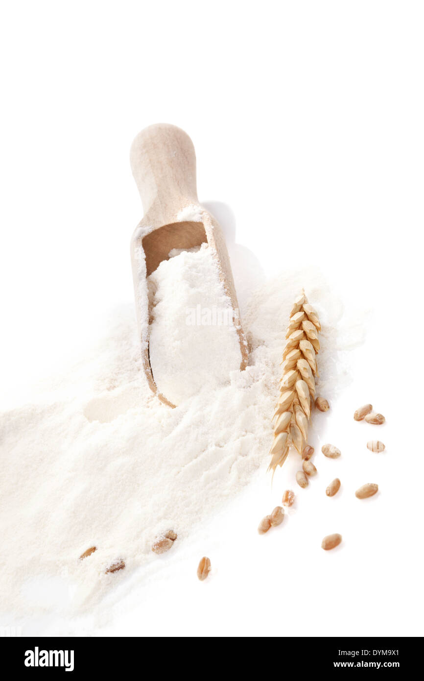 Flour and baking background. Flour on wooden spoon with rye and crop