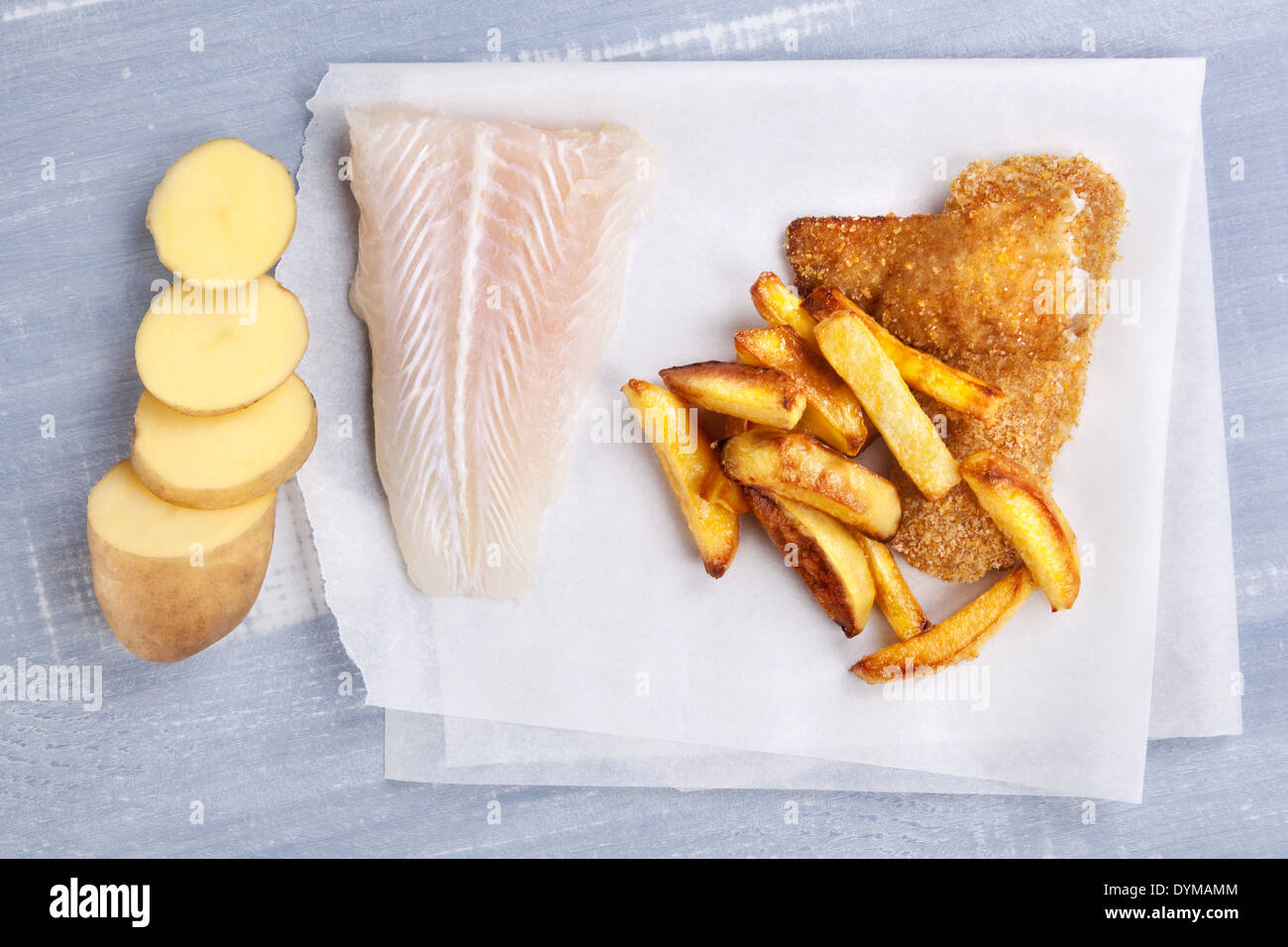 Traditional seafood eating. Raw uncooked fish fillet, fish and chips on wooden background, top view. Delicious healthy fish eat Stock Photo