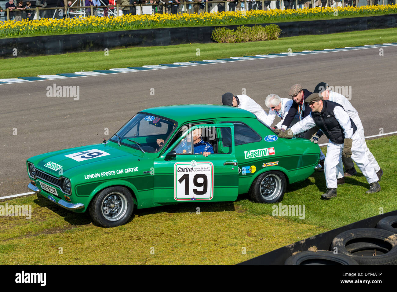 1974 Ford Escort MkI attended by marshals. Driver Peter Clements, Gerry Marshall Trophy Race. 72nd Goodwood Members meeting, UK. Stock Photo