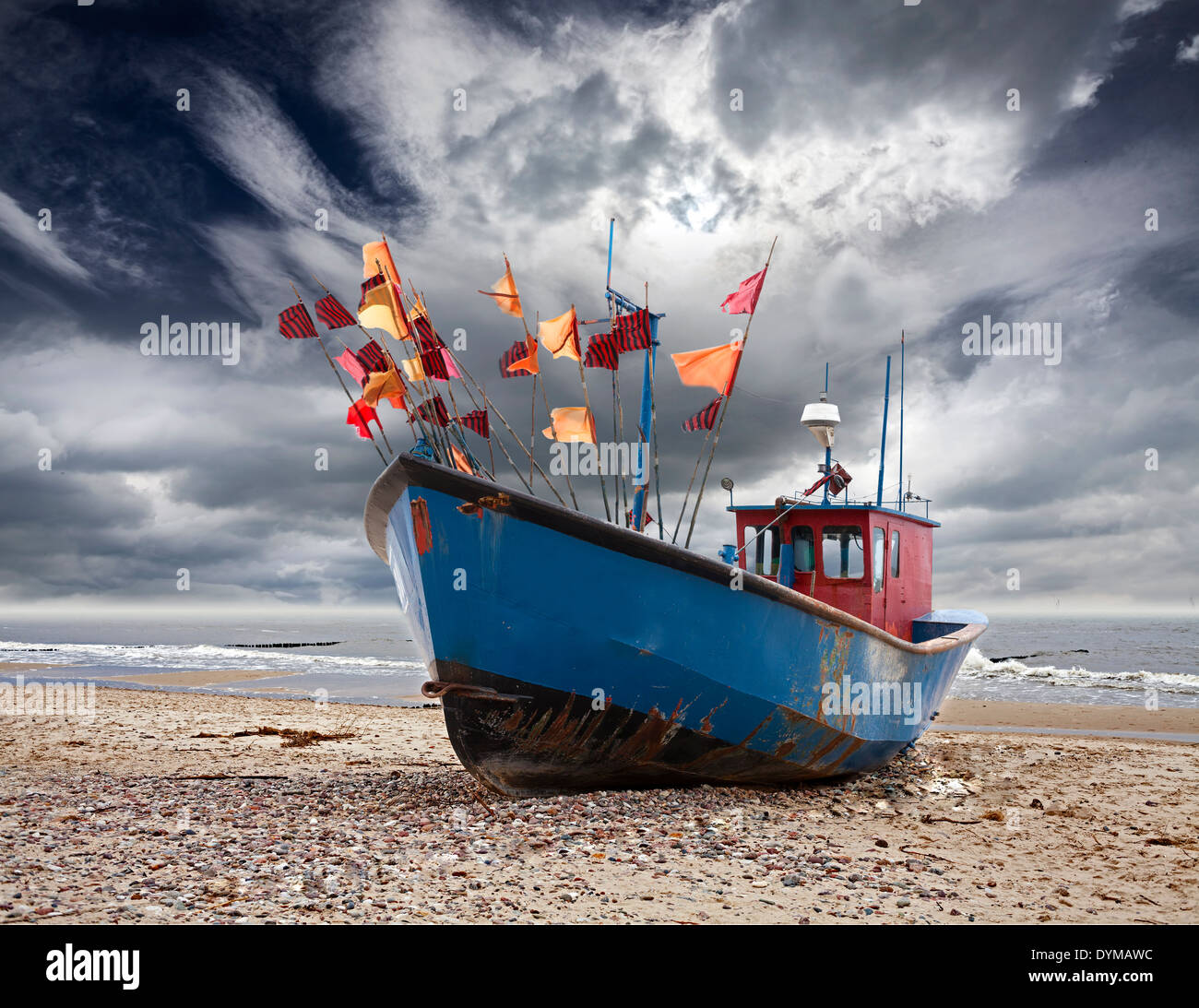 Boat on the beach, stormy sky in Miedzyzdroje, Poland. Stock Photo