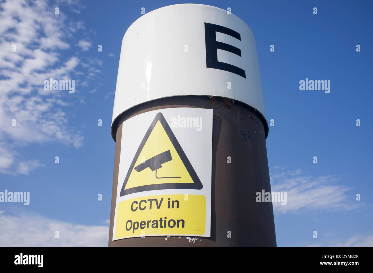 metal post with the letter E and cctv in operation sign Stock Photo