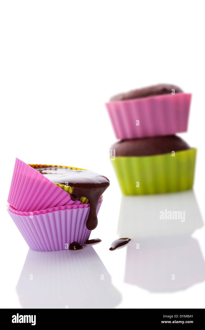 Making cupcakes. Cupcake mixture in neon colored silicone baking forms ...