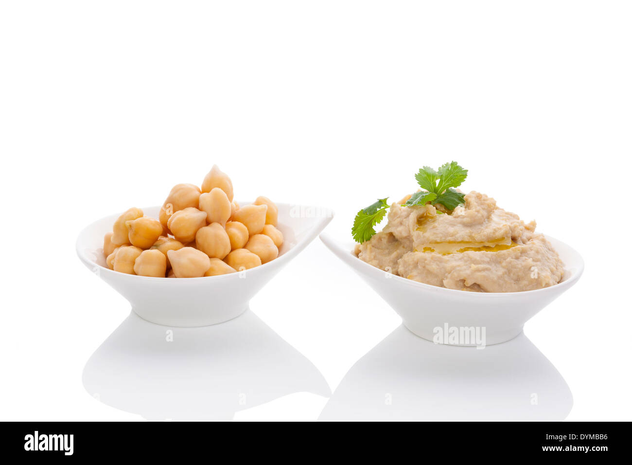 Chickpeas and hummus in bowls isolated on white background. Culinary eastern cuisine. Stock Photo
