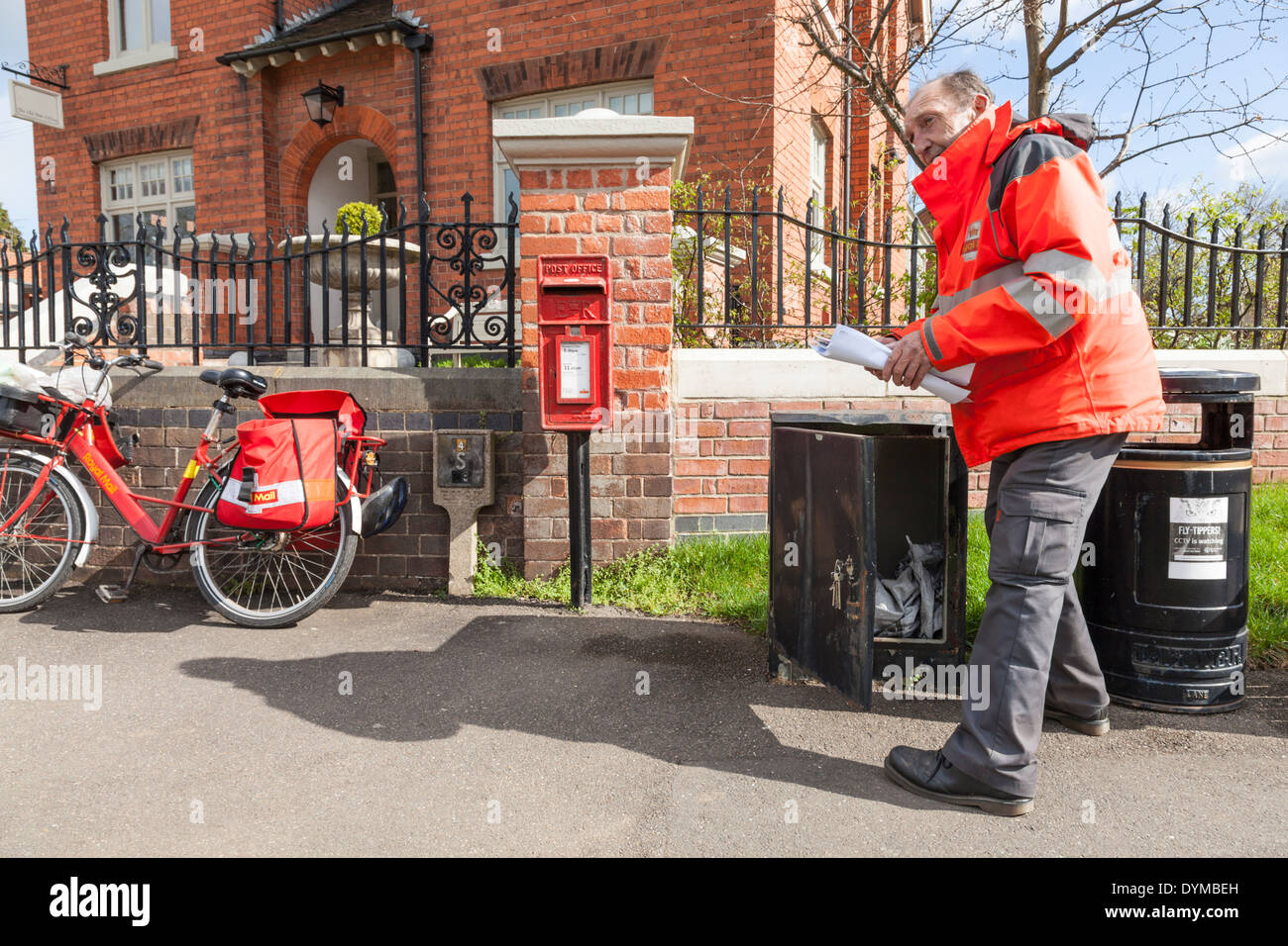 Royal mail postman collecting post from a box prior to delivery Royal mail postman collecting post from a box prior to delivery