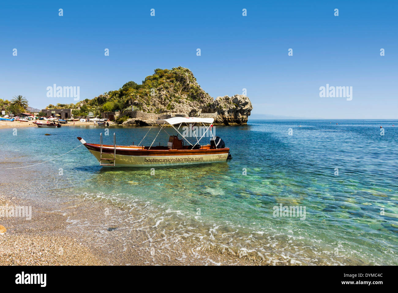 Excursion boat on Mazzaro Bay in this popular north east tourist town; Taormina, Catania Province, Sicily, Italy Stock Photo