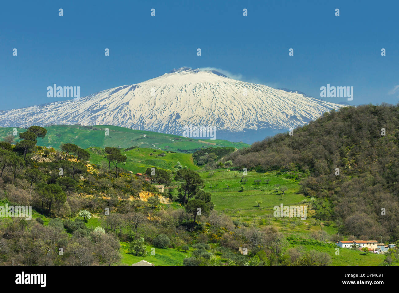 View to snow covered volcano Mount Etna in hill country near Nicosia in Spring; Nicosia, Enna Province, Sicily, Italy Stock Photo
