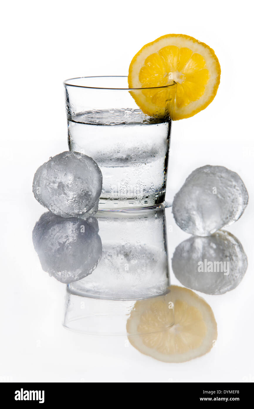 Glass of water with a lemon slice an ice cubes Stock Photo - Alamy
