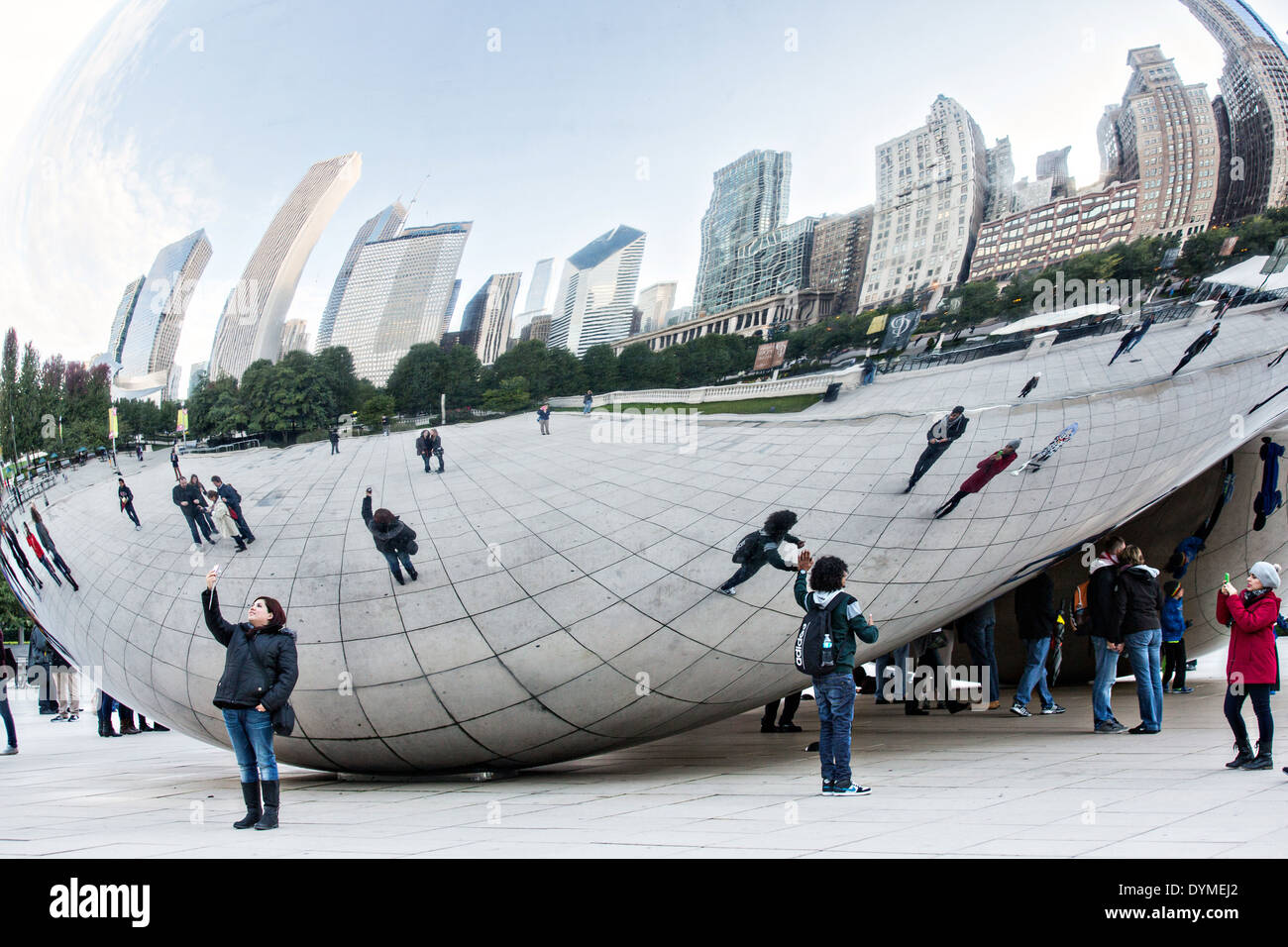 Cloud Gate Sculpture or The Bean with downtown skyline reflected in ...