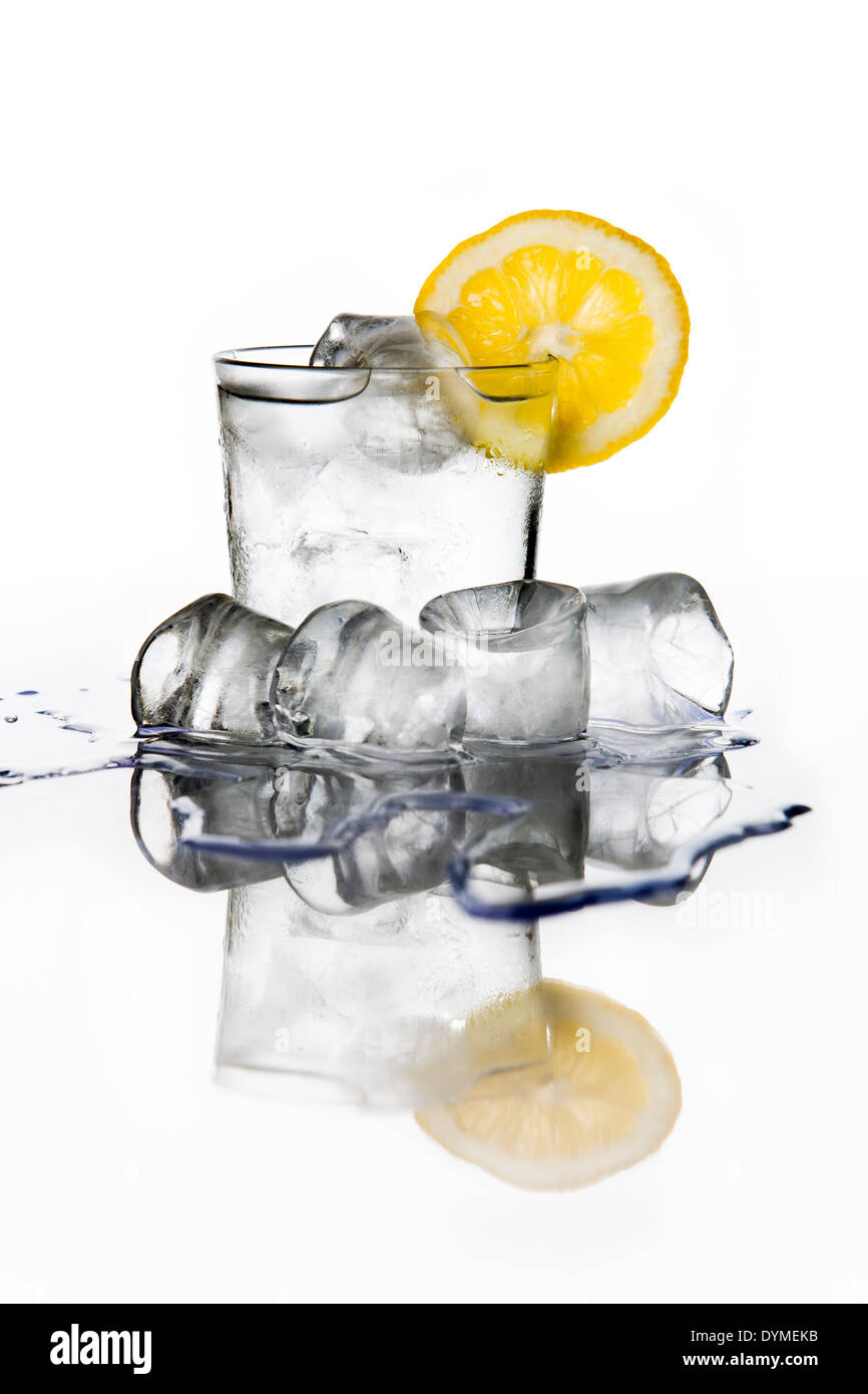 Glass of water with a lemon slice an ice cubes Stock Photo - Alamy