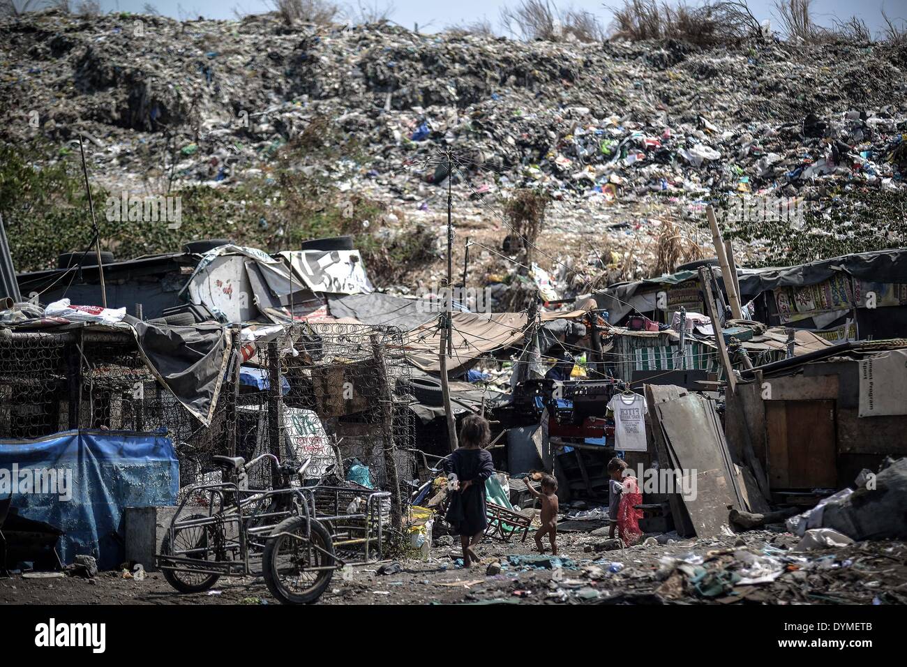 Las Pinas, Philippines. 22nd Apr, 2014. Makeshift houses are seen at a  garbage dumpsite during Earth Day in Las Pinas, south of Manila, Philippines,  April 22, 2014. The world marks Earth Day