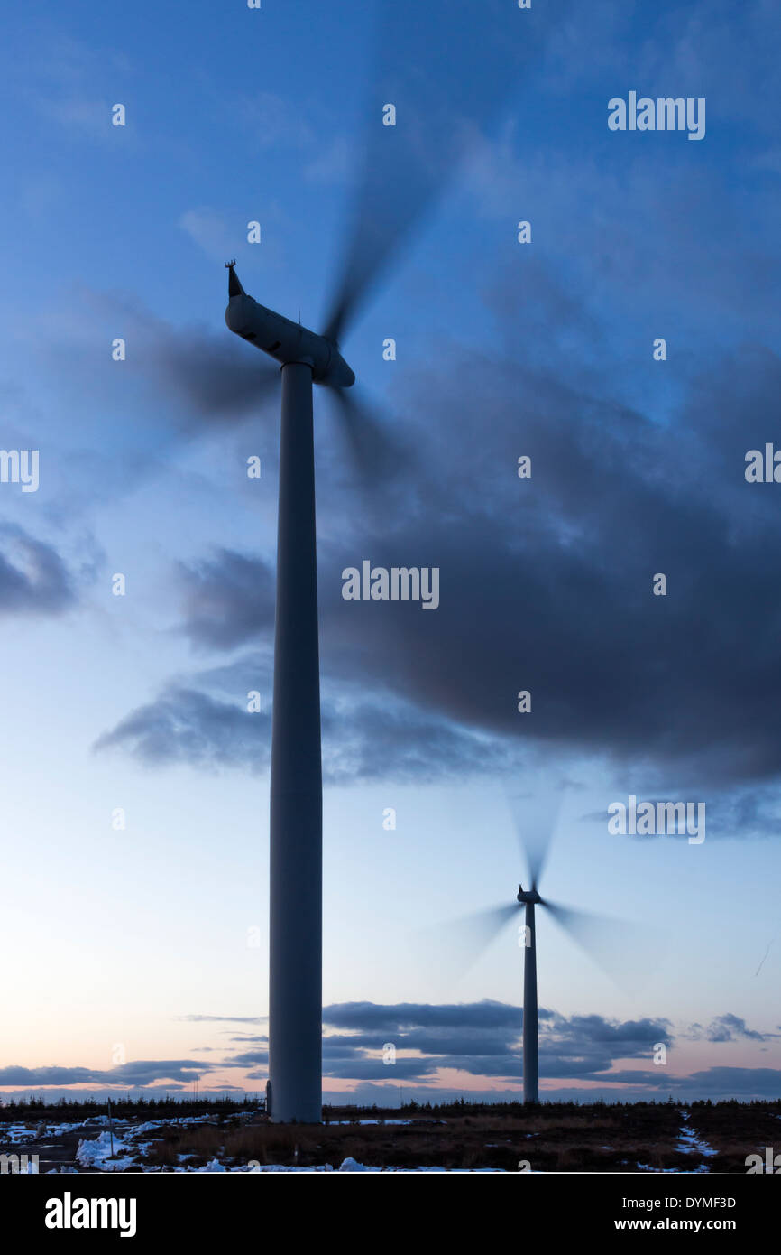 Wind turbine turning in the early evening just after sunset winter time Stock Photo