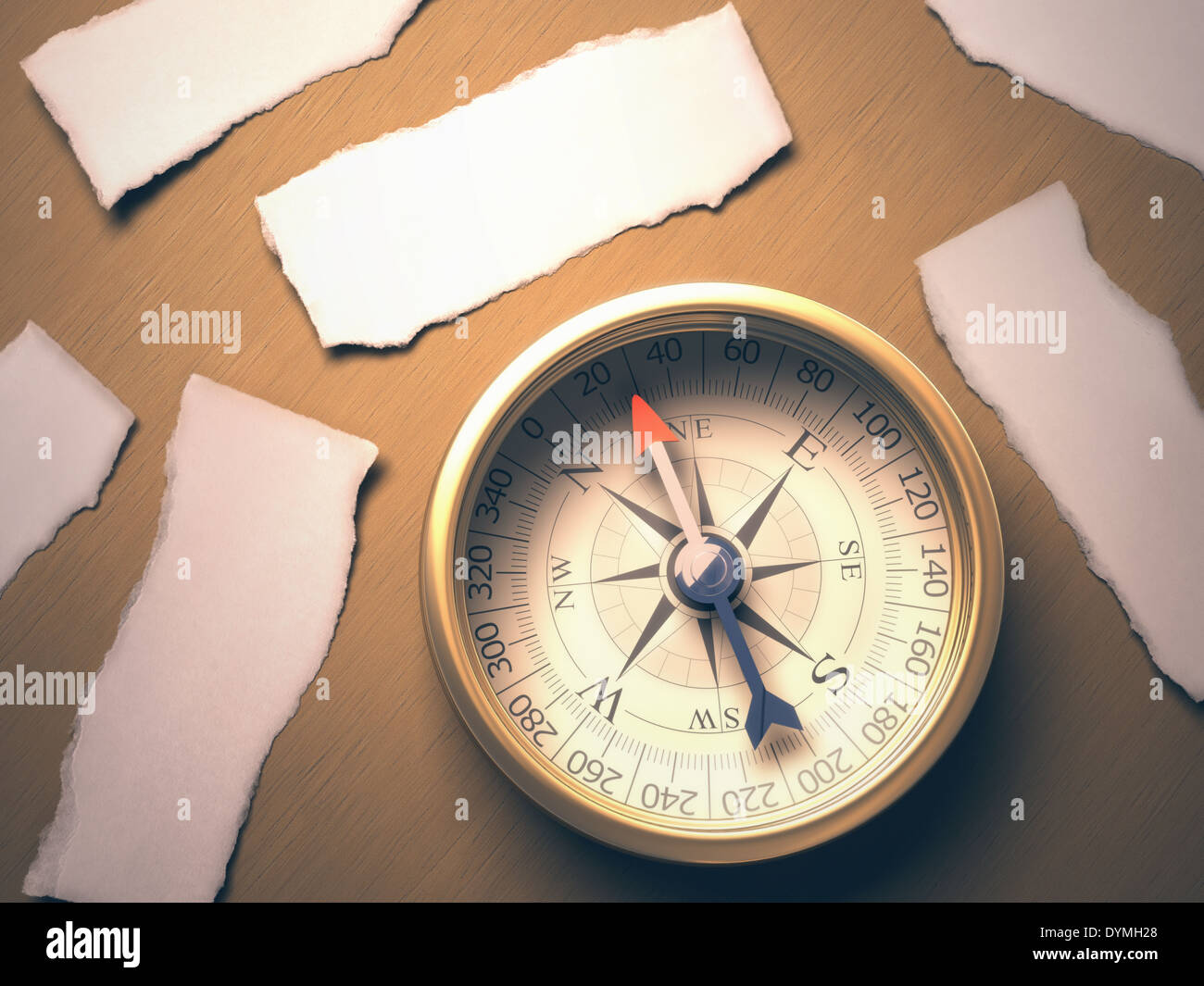 Compass indicating the best direction to take. Your text on blank pieces of paper. Clipping path included. Stock Photo
