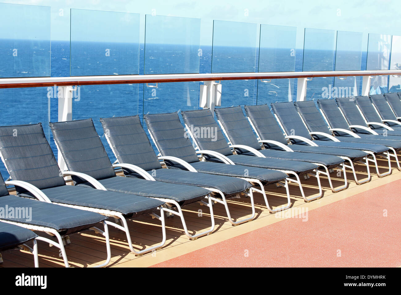Empty blue deck chairs on a cruise ship Stock Photo