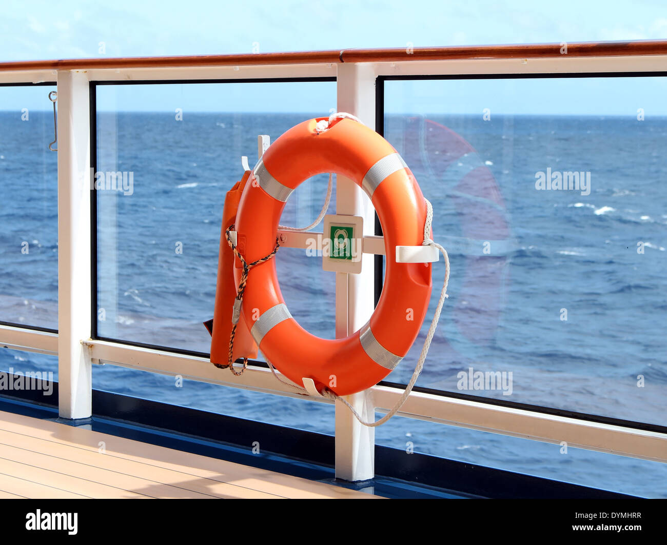 An orange lifesaver on the deck of a cruise ship Stock Photo