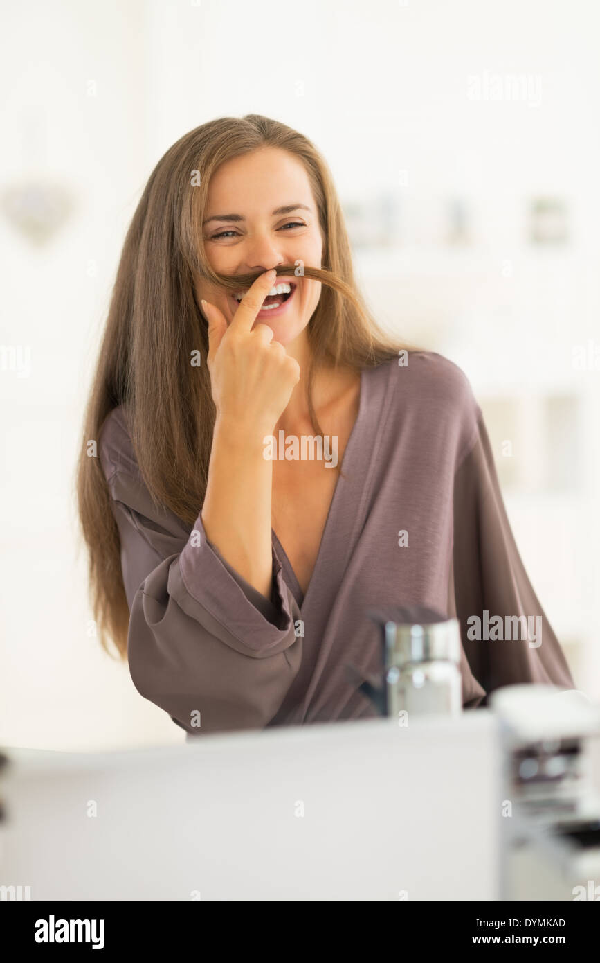 Happy young woman playing with hair Stock Photo