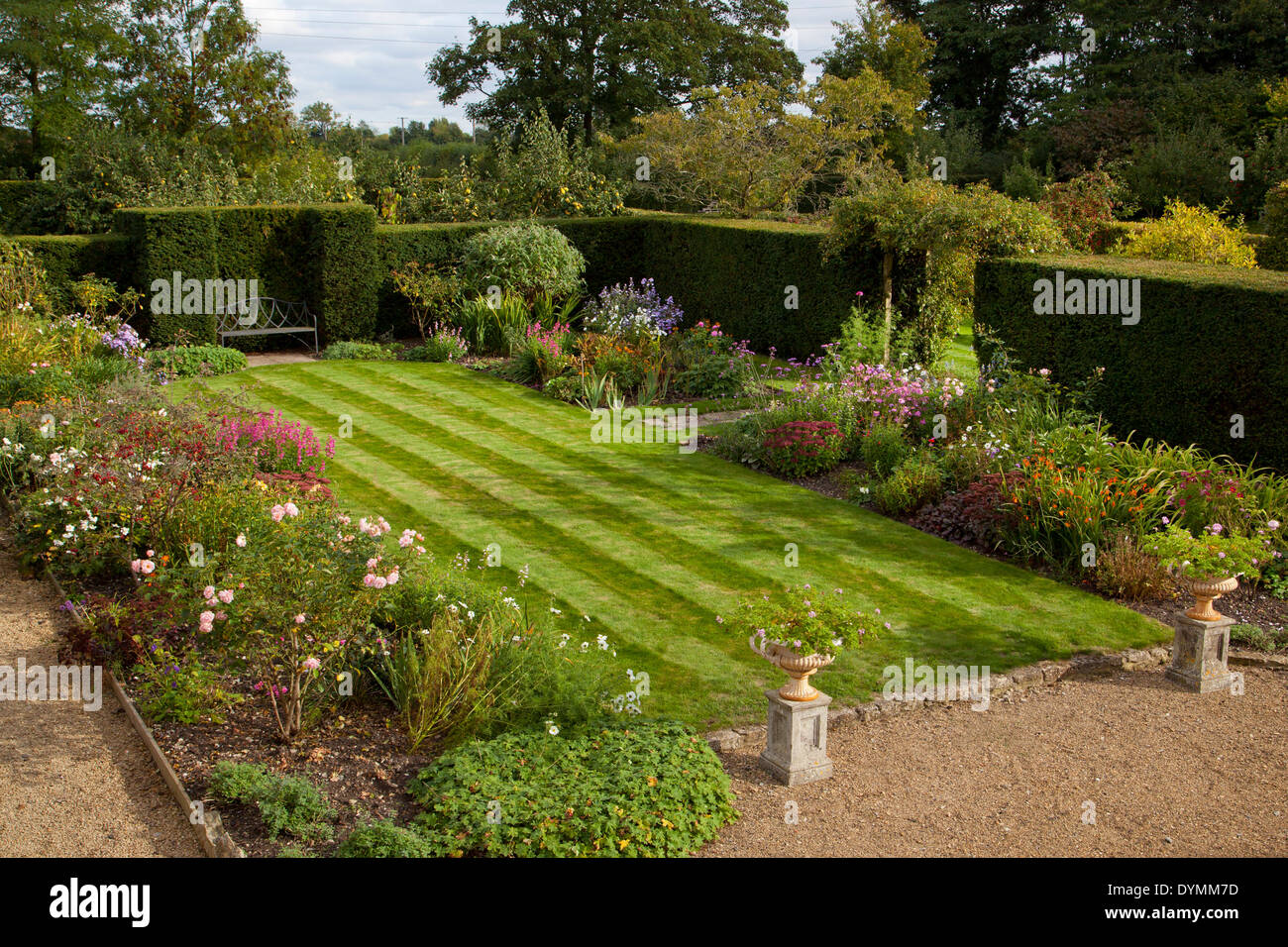 Formal English garden, with lawn surrounded by Herbaceous summer Boarders Stock Photo