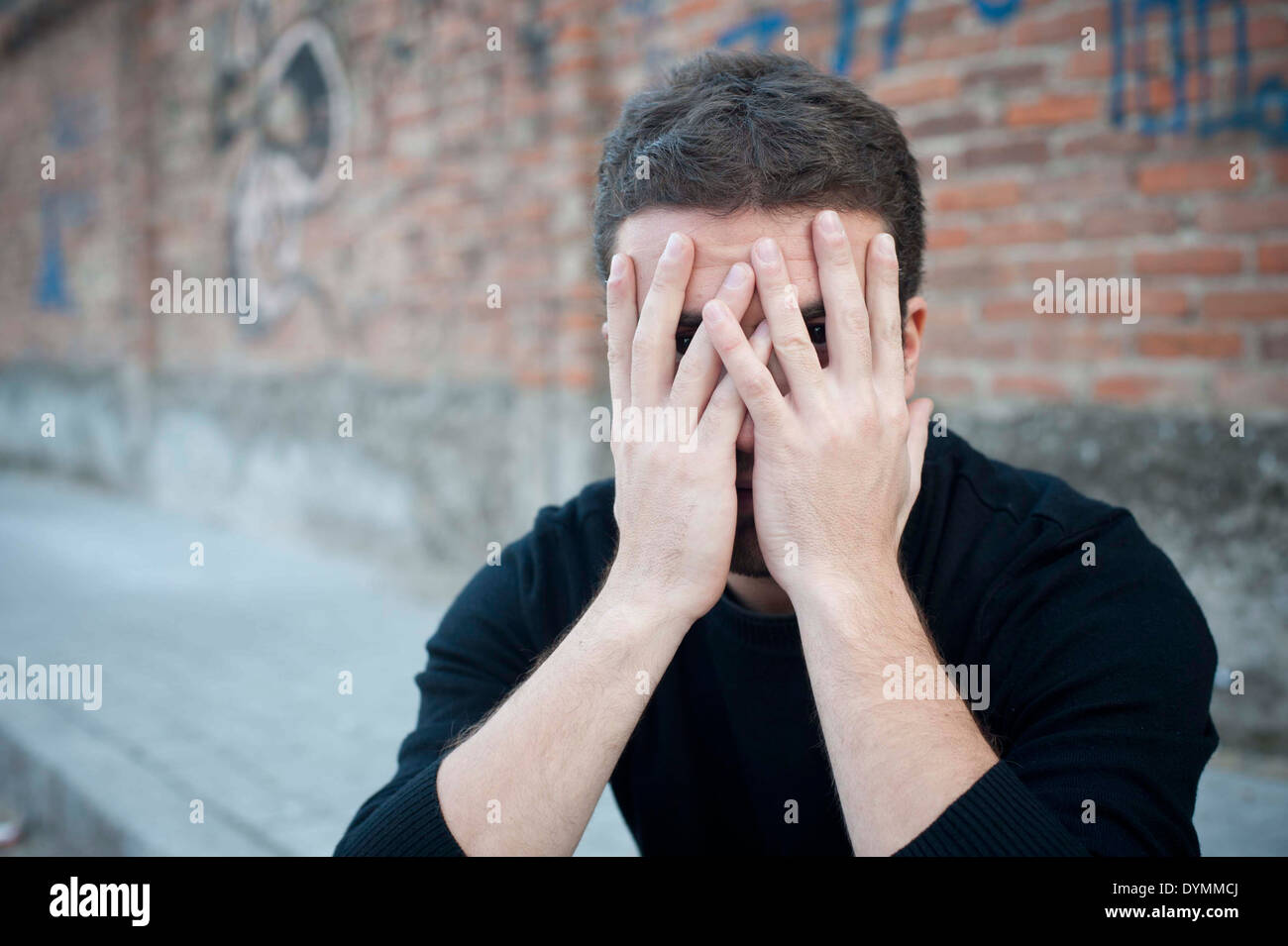portrait of a desperate man in a urban street meaning loneliness Stock