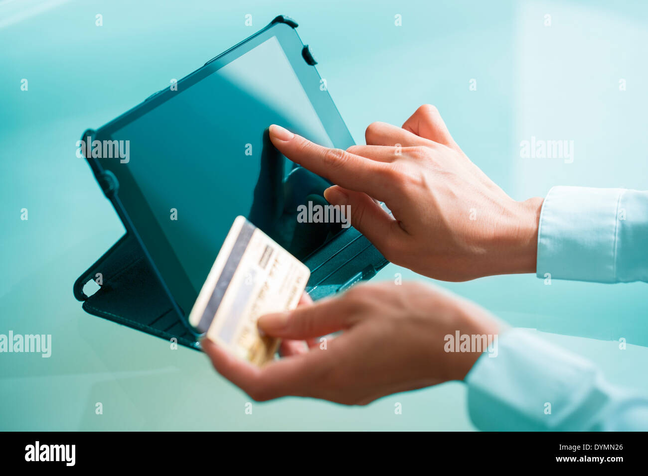 Woman shopping on internet using tablet pc and credit card Stock Photo