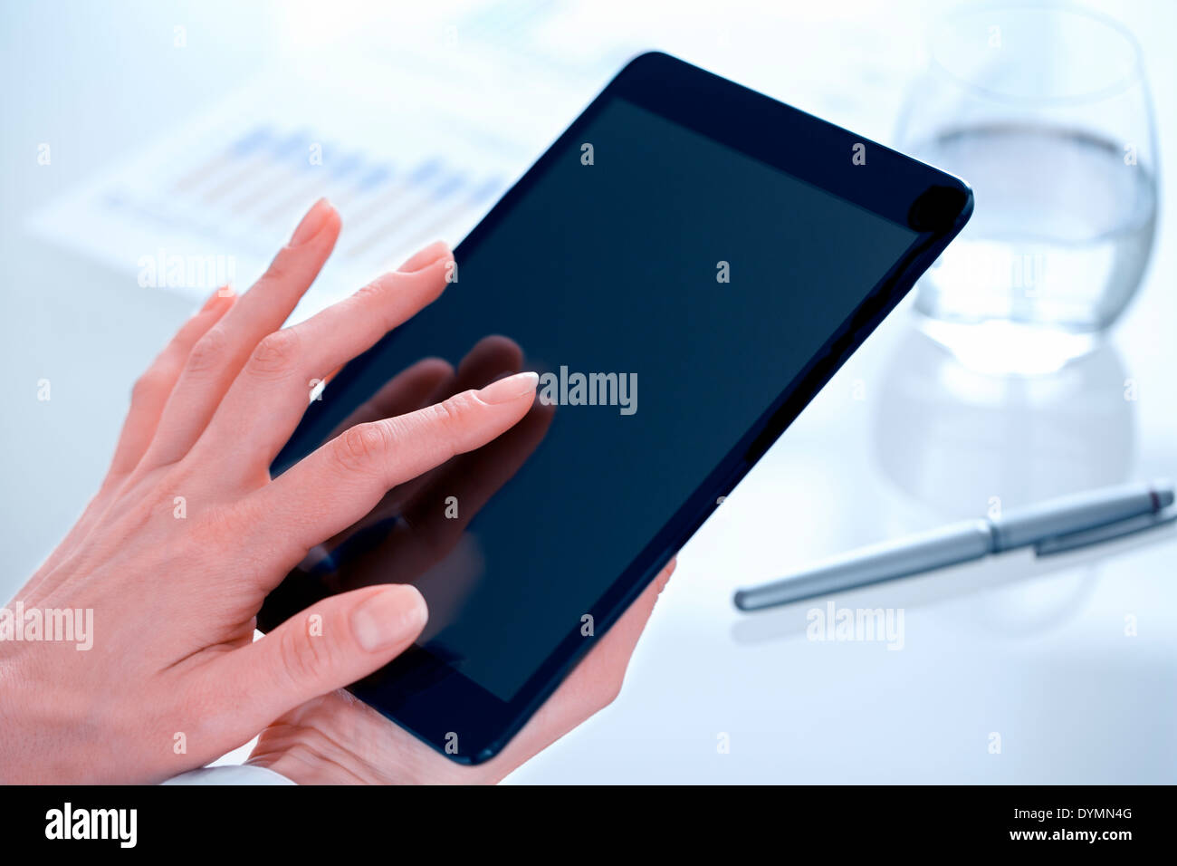 Businesswoman using digital tablet in office Stock Photo
