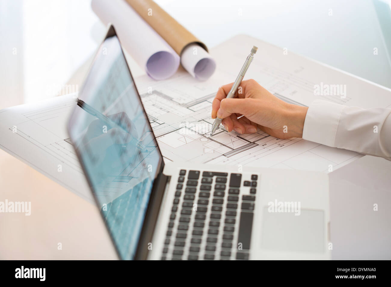 Woman Architect drawing on print construction Project Stock Photo