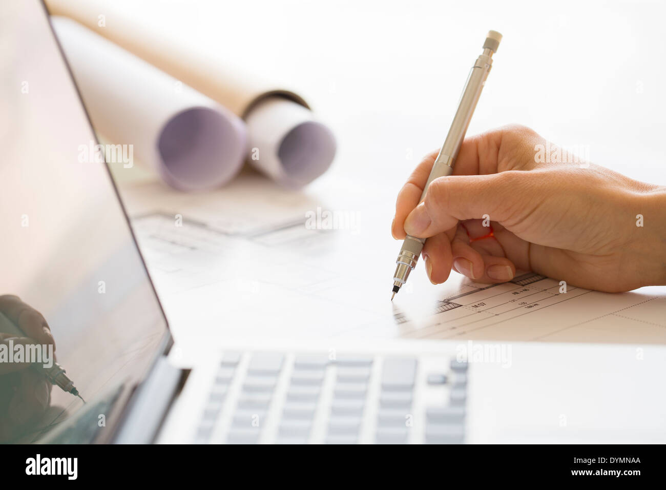Woman Architect drawing on print construction Project Stock Photo