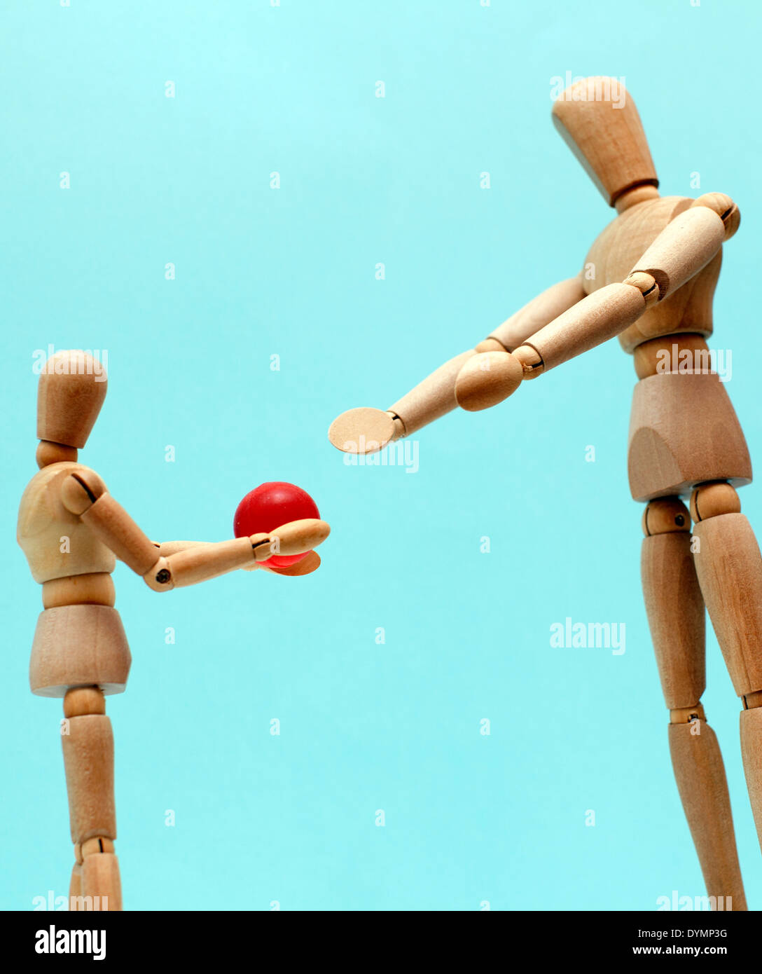 Parent and child playing with ball represented by wooden mannequins, London Stock Photo